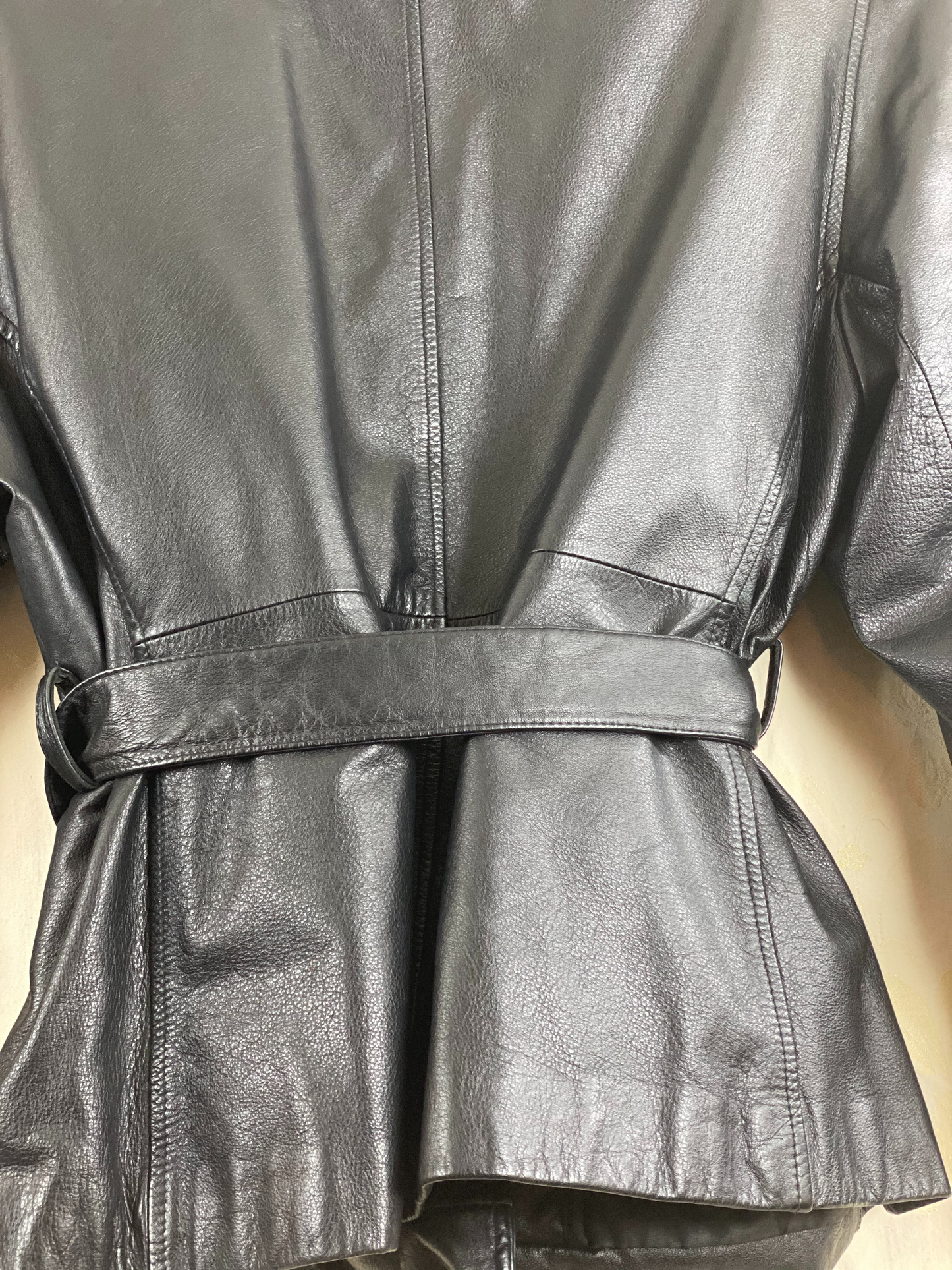 Pre-Owned - Excellent Condition Soft-Leather Coat Size Large Two (2) Button & Belt Front Closure Removable Lining Two (2) Front/Side Pockets 25” Shoulder to Bottom; 23” Sleeve; 22” Across Chest