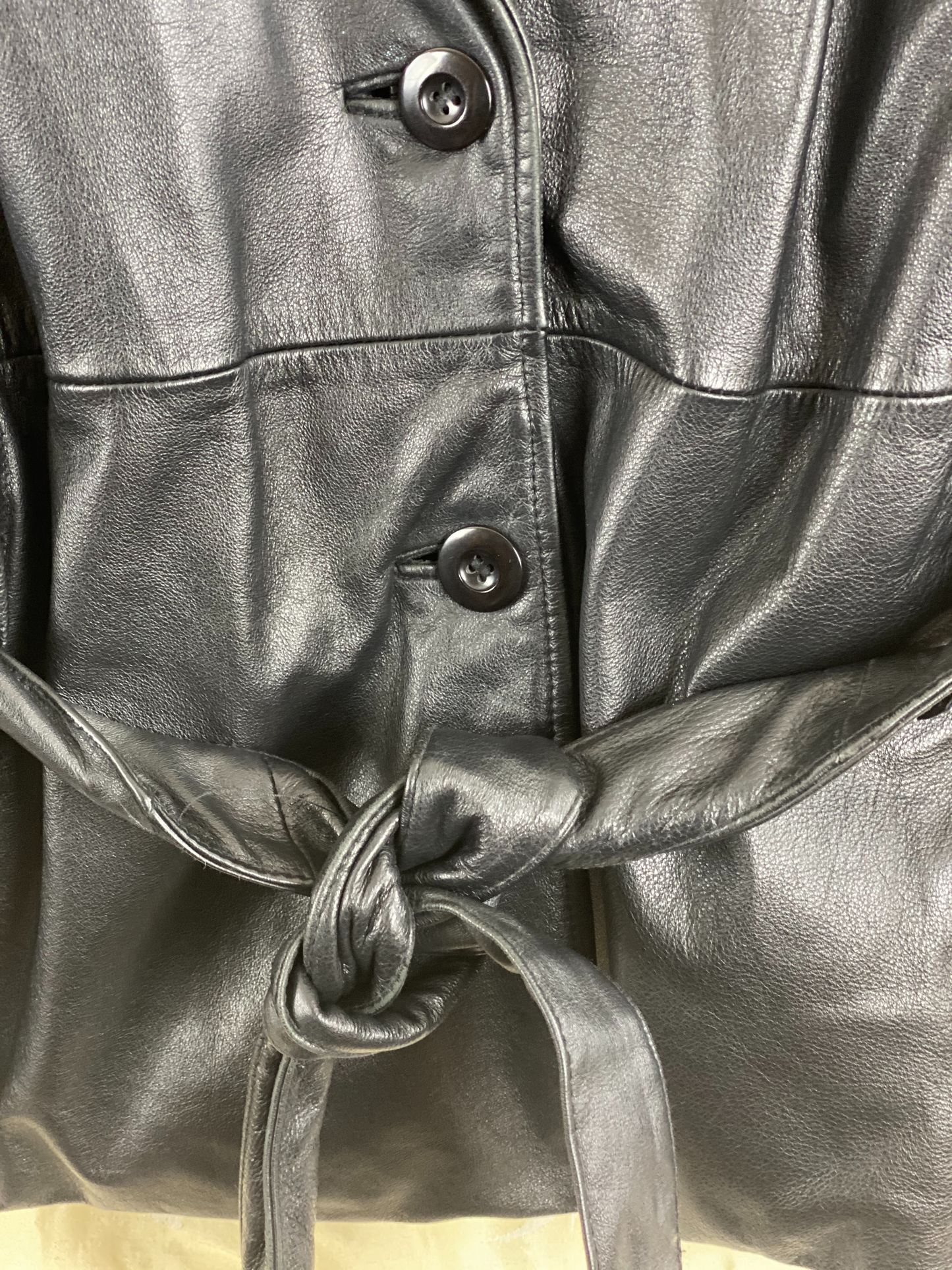 Pre-Owned - Excellent Condition Soft-Leather Coat Size Large Two (2) Button & Belt Front Closure Removable Lining Two (2) Front/Side Pockets 25” Shoulder to Bottom; 23” Sleeve; 22” Across Chest