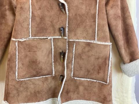 Tan Suede Girl’s Coat Size 8 Fleece Lined Fleece around Collar, Cuffs and Bottom Toggle Buttons for Closure Two (2) Large Front Pockets 24” Shoulder to Bottom 19” Sleeve Length 16” Across Chest
