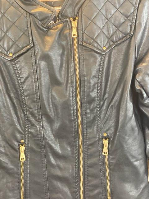 Leather-Like Black Jacket - Ci Sono by Cavalini Size Small Gold-Tone Zipper Front Closure Gold-Tone Zipper Two (2) Front Pockets Gold-Tone Zipper on Each Sleeve Gold-Tone Studs on Shoulders Quilted Trim on Shoulders and Back Skull Design on Lining 19” Shoulder to Bottom; .24” Sleeve; 17” Across Chest