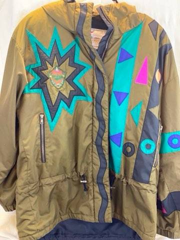 Pea Green - Geometric Pattern/Design on Coat Medium Size Polyester Lining Zipper and Snap Front Closure Two (2) Zipper Front Pockets Two (2) Inside Pockets Attached Hood 27” Length 23” Sleeve 23” Chest