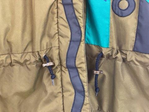 Pea Green - Geometric Pattern/Design on Coat Medium Size Polyester Lining Zipper and Snap Front Closure Two (2) Zipper Front Pockets Two (2) Inside Pockets Attached Hood 27” Length 23” Sleeve 23” Chest