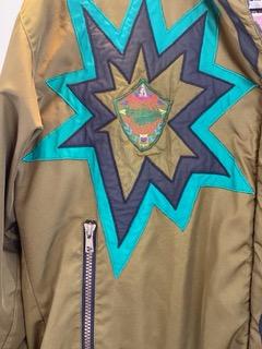 Pea Green - Geometric Pattern/Design on Coat Medium Size Polyester Lining Zipper and Snap Front Closure Two (2) Zipper Front Pockets Two (2) Inside Pockets Attached Hood 27” Length 23” Sleeve 23” Chest