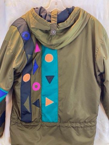 Pea Green - Geometric Pattern/Design on Coat Medium Size Polyester Lining Zipper and Snap Front Closure Two (2) Zipper Front Pockets Two (2) Inside Pockets Attached Hood 27” Length 23” Sleeve 23” Chest