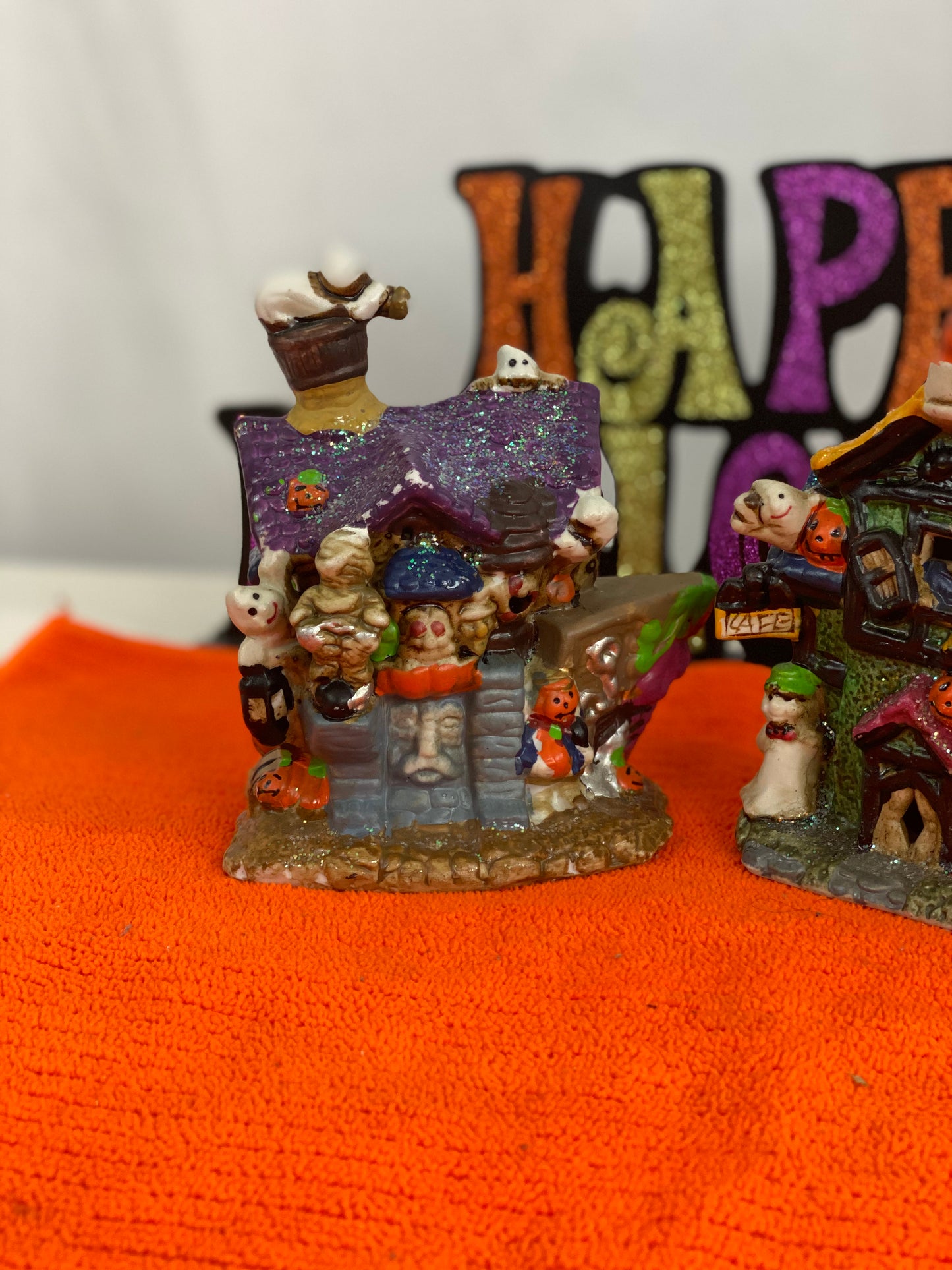 Set of Haunted Houses - Two (2) Ceramic With Sparkly Finish Many Decorations on Each House Each House is Approx. 5”H x 4” W Electric-Illumination