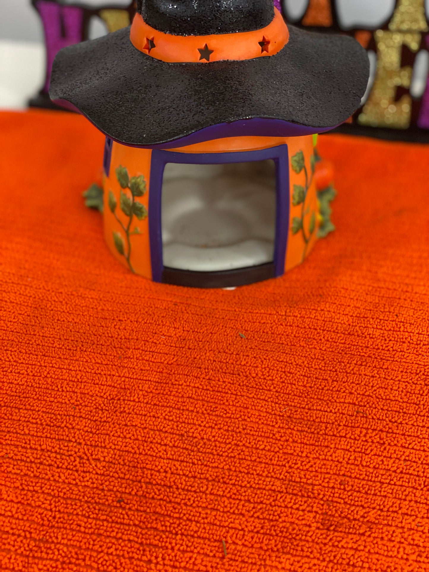 Ceramic Witch’s Home Decorated with: Witch Hat Roof Witch’s Shoes at Doorstep Witch’s Broom Spider Web Pumpkins Opening for candle for Lighting
