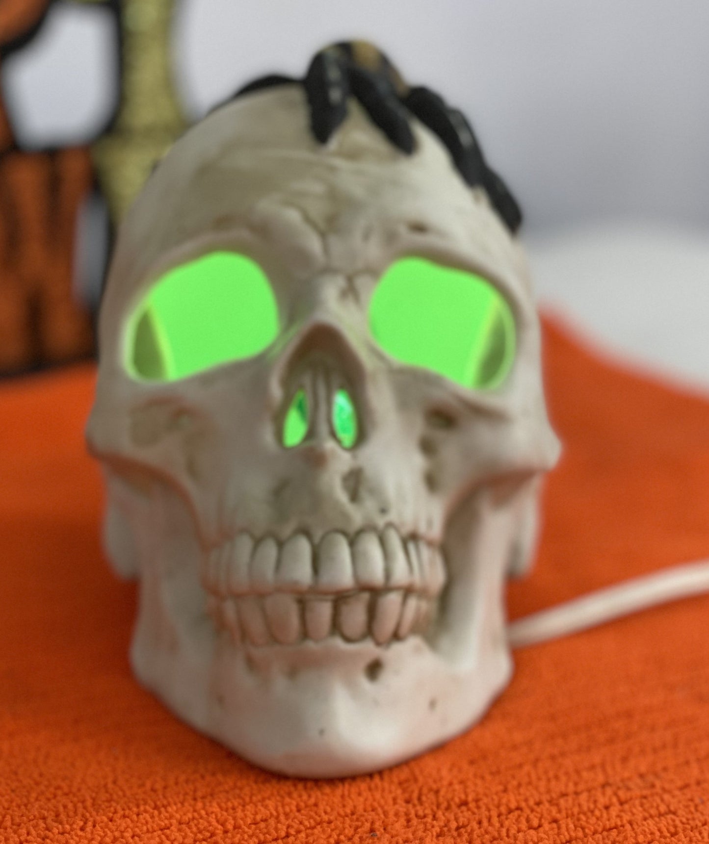 Seasonal-Halloween Ceramic Skull with Spider on Top of Skull Electric-Illumination Approx 5” H x 3.5 Wide Made in Taiwan