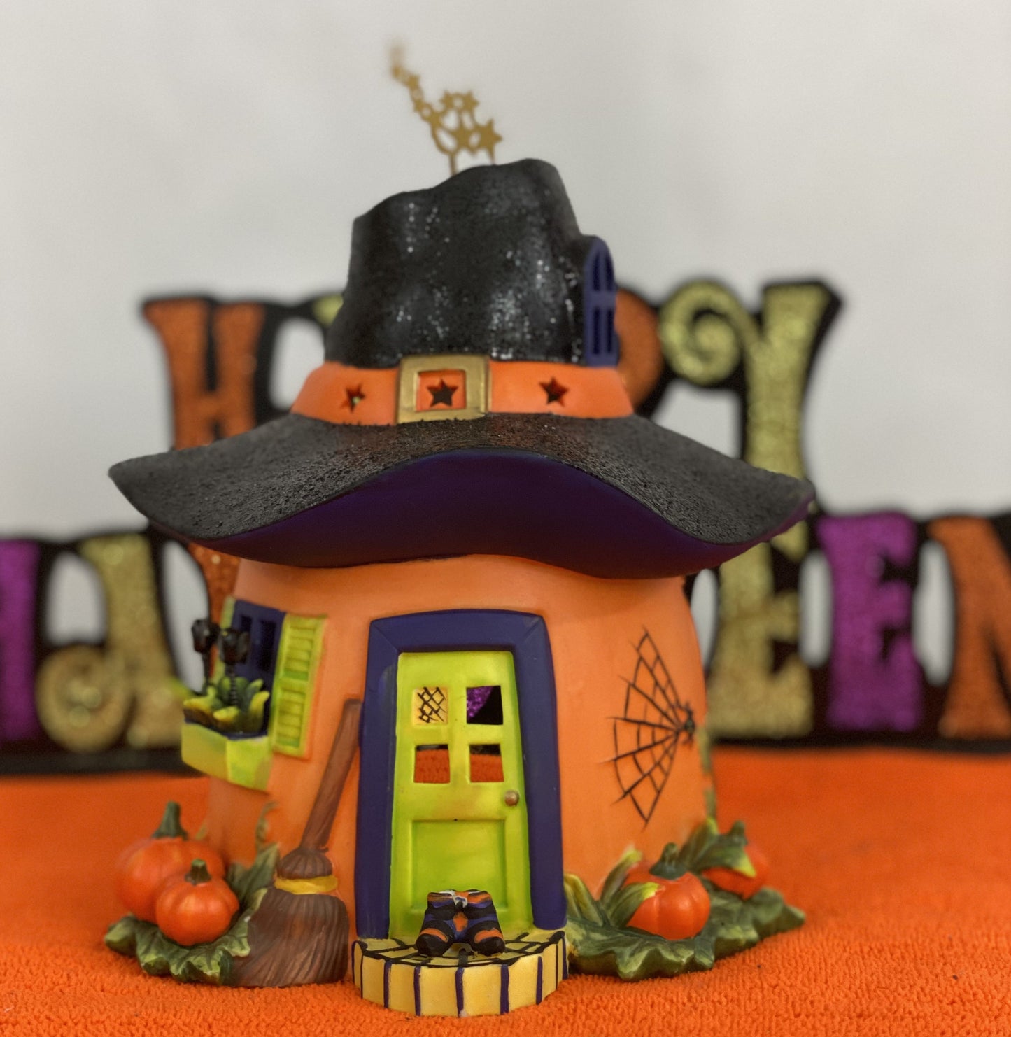 Ceramic Witch’s Home Decorated with: Witch Hat Roof Witch’s Shoes at Doorstep Witch’s Broom Spider Web Pumpkins Opening for candle for Lighting