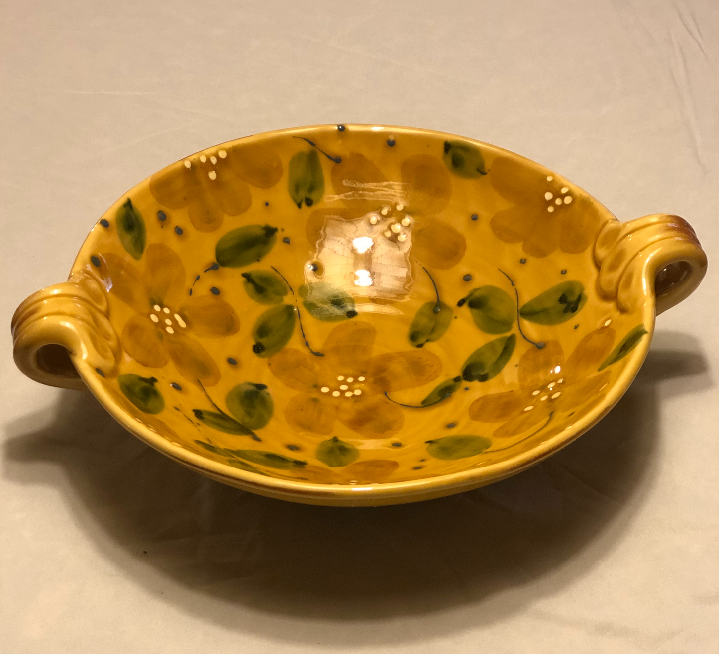 Ceramic Bowl - Approx: 12” Diameter Two (2) handles for easy carrying Handle-to-Handle - Approx: 15” Gold Background with Green & Cream Leaf Design Made in Italy for Vietri
