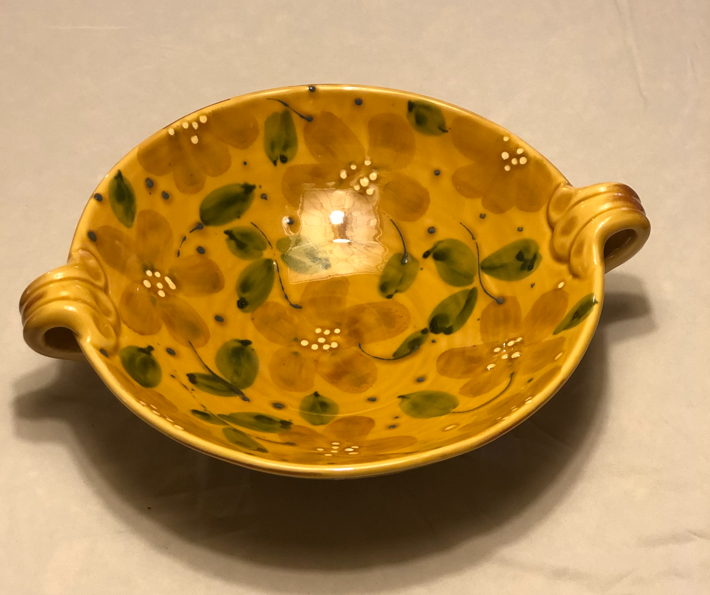Ceramic Bowl - Approx: 12” Diameter Two (2) handles for easy carrying Handle-to-Handle - Approx: 15” Gold Background with Green & Cream Leaf Design Made in Italy for Vietri