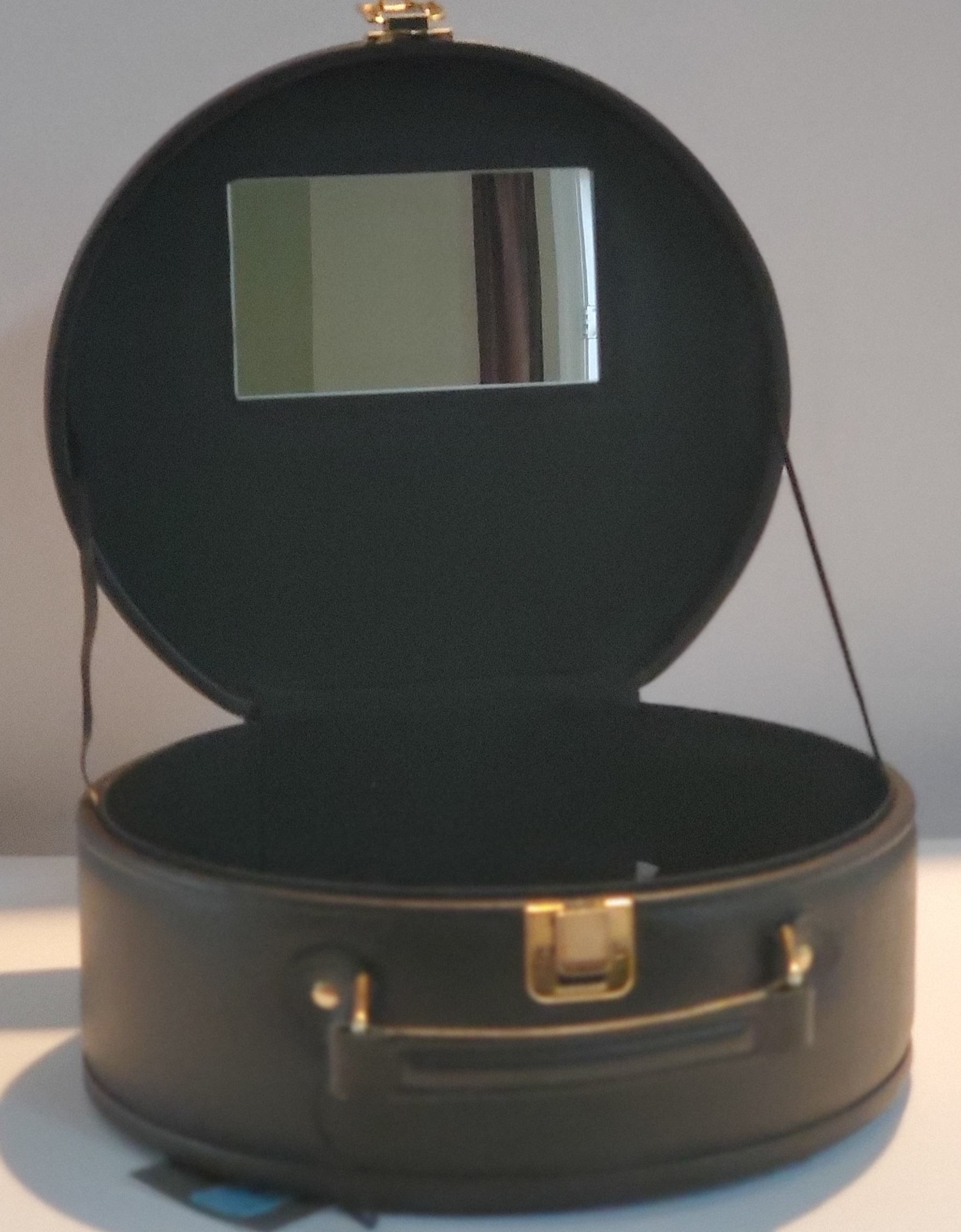 Leather Cosmetic Bag with Leopard Accent On Top and Bottom  Leather Handle for Carrying  Gold-Tone Clasp for Secure Closure  Approx Size:  11” W x 10” H x 5”  D  Round Shape