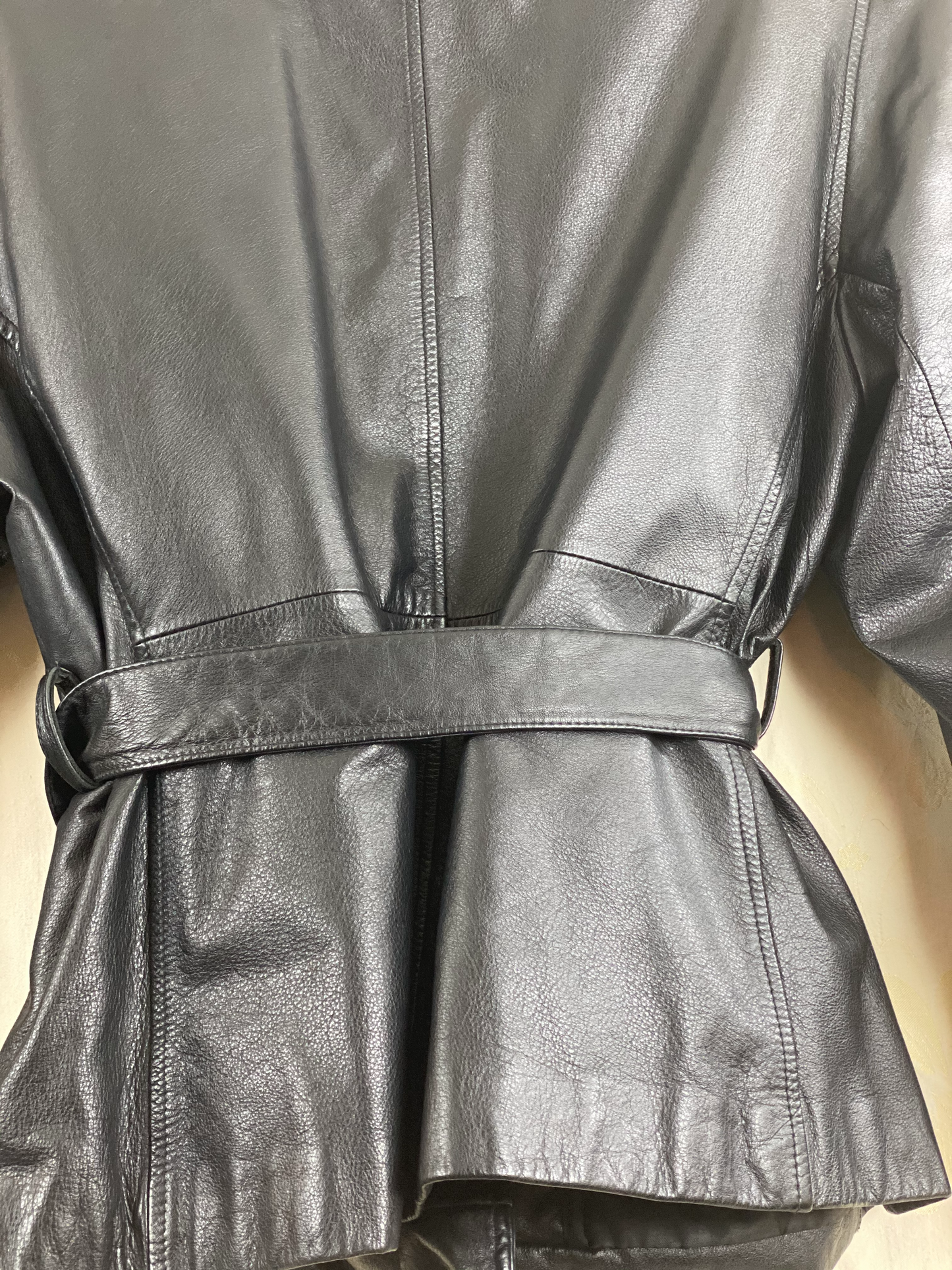 Pre-Owned - Excellent Condition   Soft-Leather Coat  Size Large  Two (2) Button & Belt Front Closure  Removable Lining  Two (2) Front/Side Pockets  25” Shoulder to Bottom; 23” Sleeve; 22” Across Chest