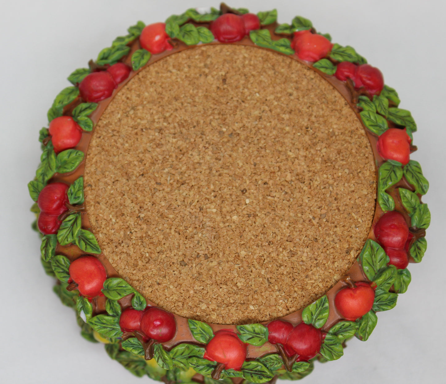 Set of 4 Coasters -  Apple Pattern (2), Grape   Pattern (1); Pear Pattern (1)  Russ Wine Cellar - Berrie and Company  Approx:  3.75” Round  Ceramic With Cork Inlay
