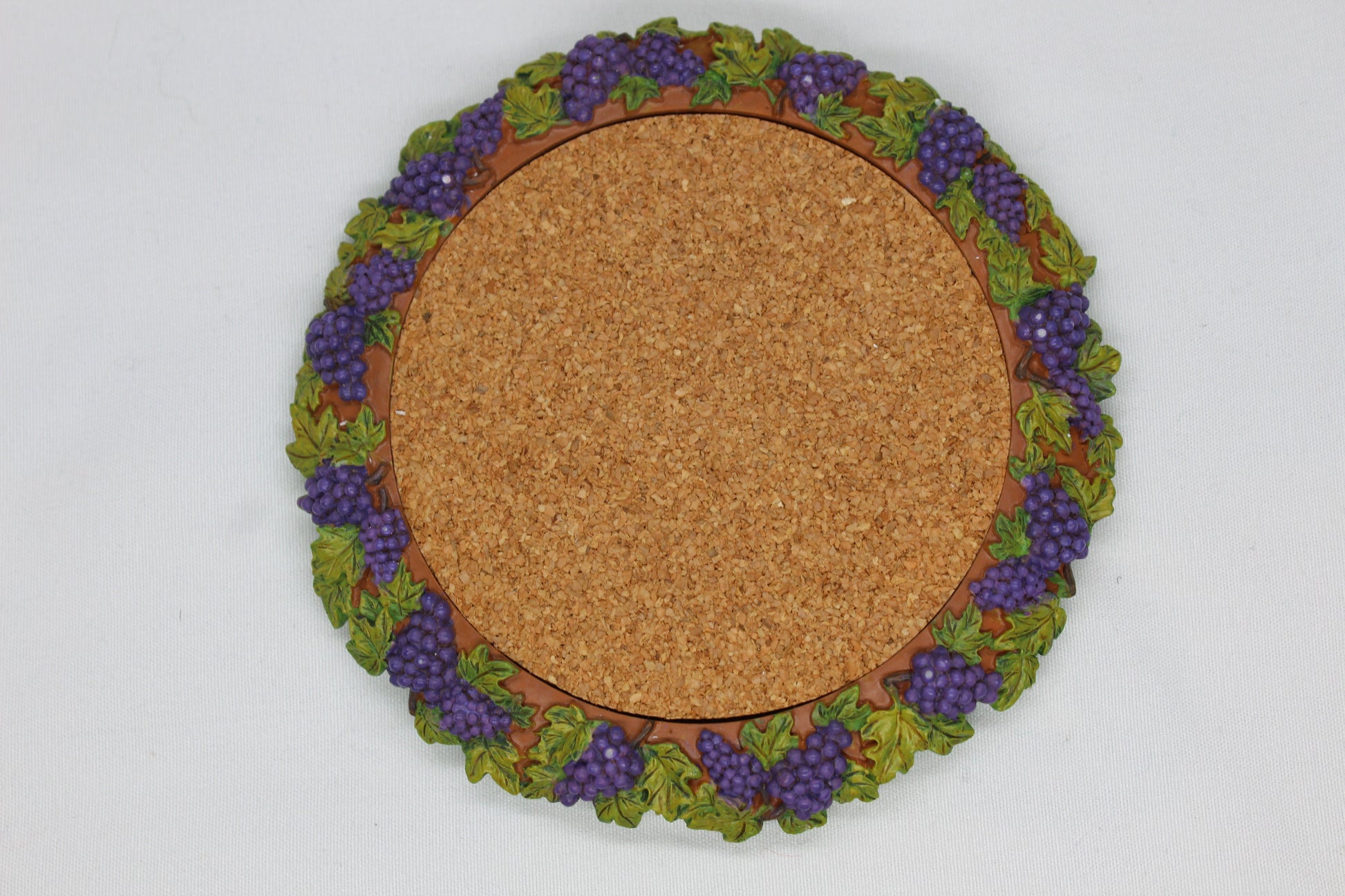 Set of 4 Coasters -  Apple Pattern (2), Grape   Pattern (1); Pear Pattern (1)  Russ Wine Cellar - Berrie and Company  Approx:  3.75” Round  Ceramic With Cork Inlay