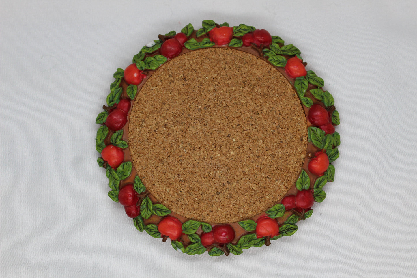 Set of 4 Coasters -  Apple Pattern (2), Grape   Pattern (1); Pear Pattern (1)  Russ Wine Cellar - Berrie and Company  Approx:  3.75” Round  Ceramic With Cork Inlay