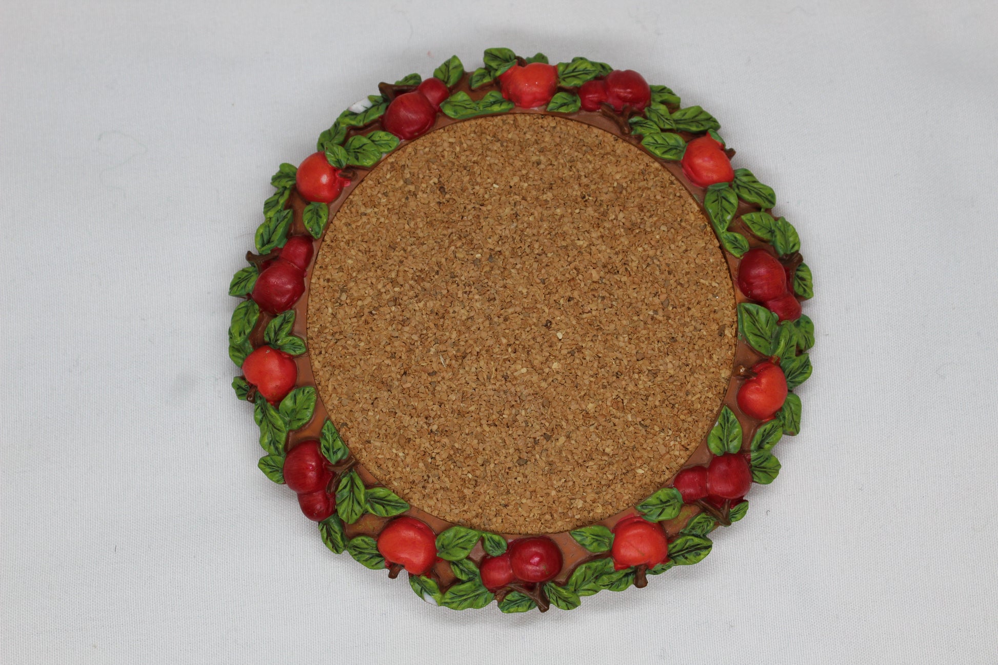 Set of 4 Coasters -  Apple Pattern (2), Grape   Pattern (1); Pear Pattern (1)  Russ Wine Cellar - Berrie and Company  Approx:  3.75” Round  Ceramic With Cork Inlay