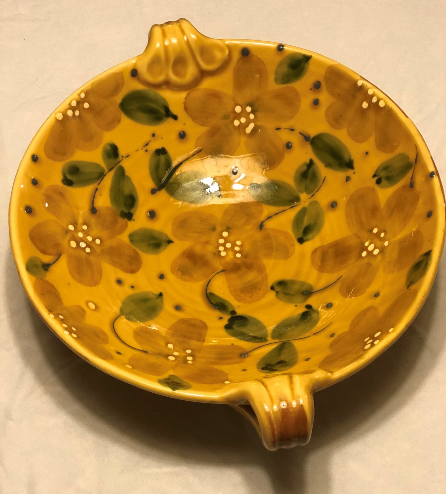 Ceramic Bowl - Approx: 12” Diameter  Two (2) handles for easy carrying  Handle-to-Handle - Approx: 15”  Gold Background with Green & Cream Leaf Design  Made in Italy for Vietri