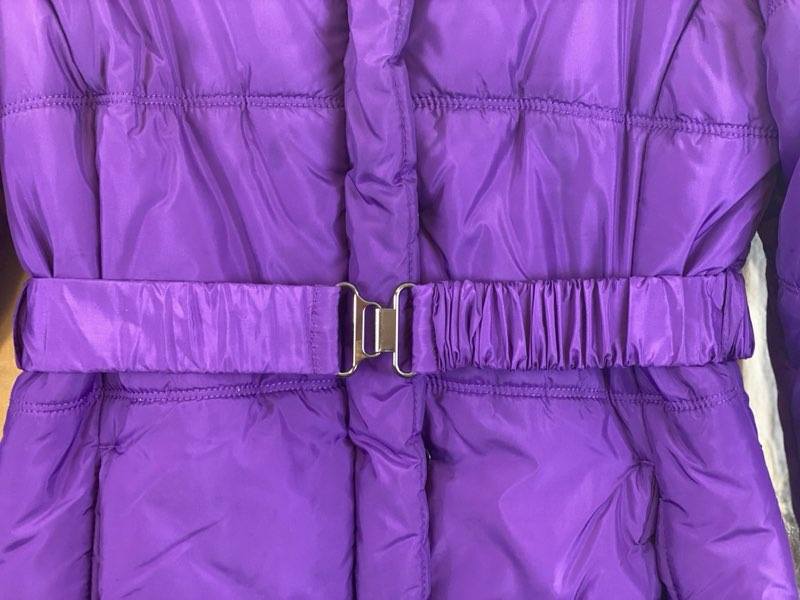 Deep Purple Coat  Large (12-14)  Attached Hood with Furry Trim  Front Zipper and Snap Closures  Two (2) Front Pockets  Waist Belt with Hook Closure  30” Shoulder to Bottom  24” Sleeve Length  17” Across Chest