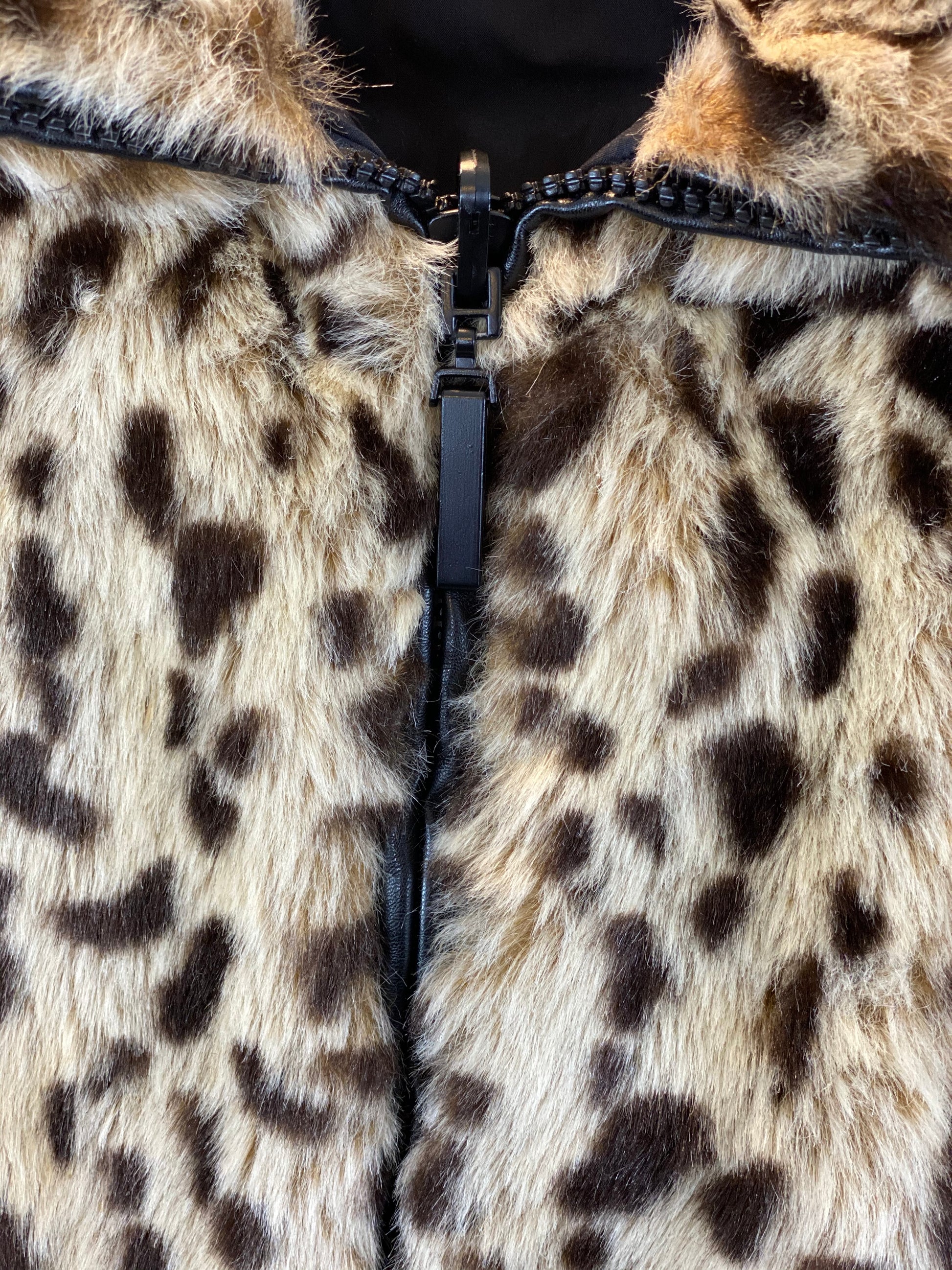 Pre-Owned - Excellent Condition   Furry Leopard Print  Front Zipper Closure   Two (2) Outside Pockets  Two (2) Inside Pockets   Leopard Collar