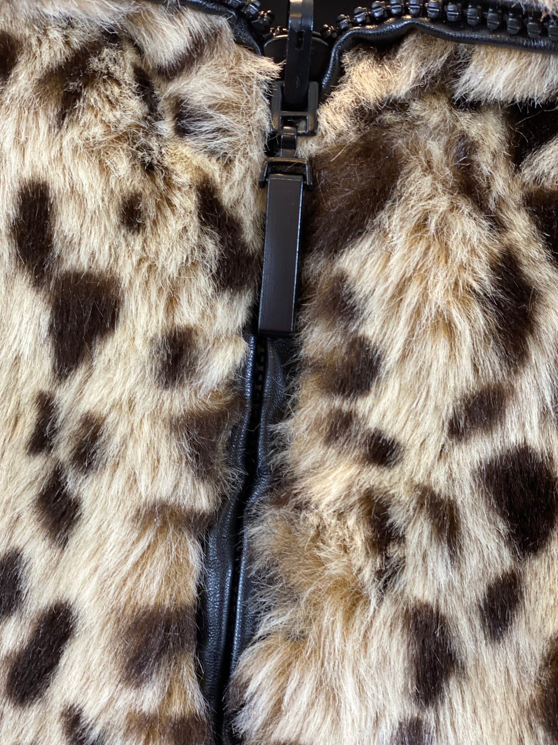 Pre-Owned - Excellent Condition   Furry Leopard Print  Front Zipper Closure   Two (2) Outside Pockets  Two (2) Inside Pockets   Leopard Collar