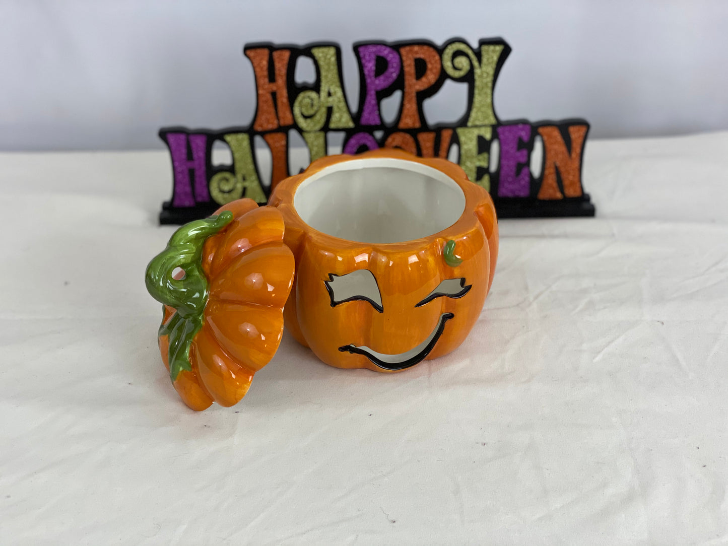 Approximate Size - 7” x 7”  Cut-out Facial Features  Includes Votive Candle  Pumpkin Only - Does Not Include “Happy Halloween” Sign