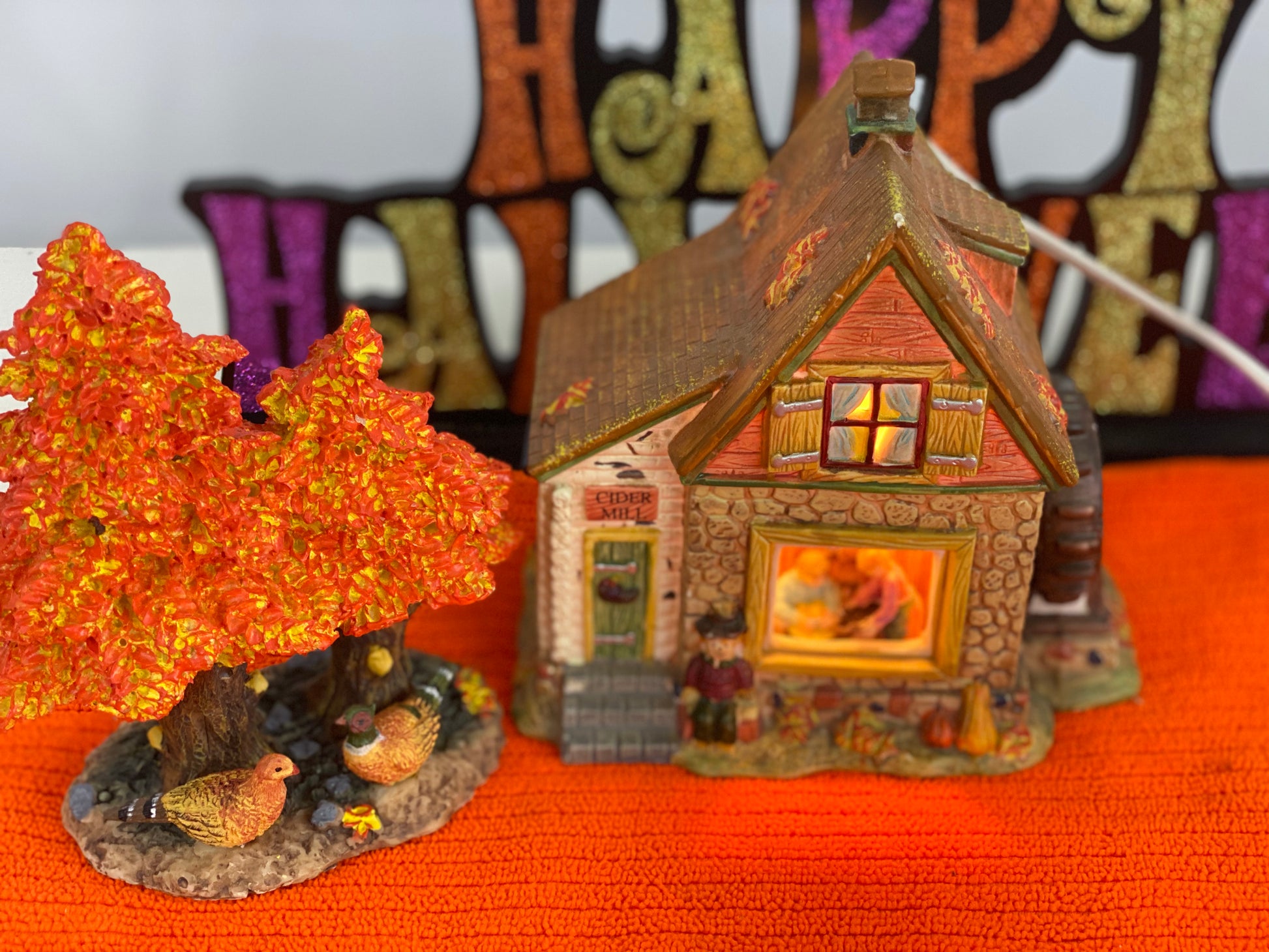 Ceramic  House/Cider Mill with Tree  House Approx.  6.5” H x 6” W  House is Electric/Illuminated with Autumn Decor  Tree is 6” H x 3.5 W with Autumn Decor