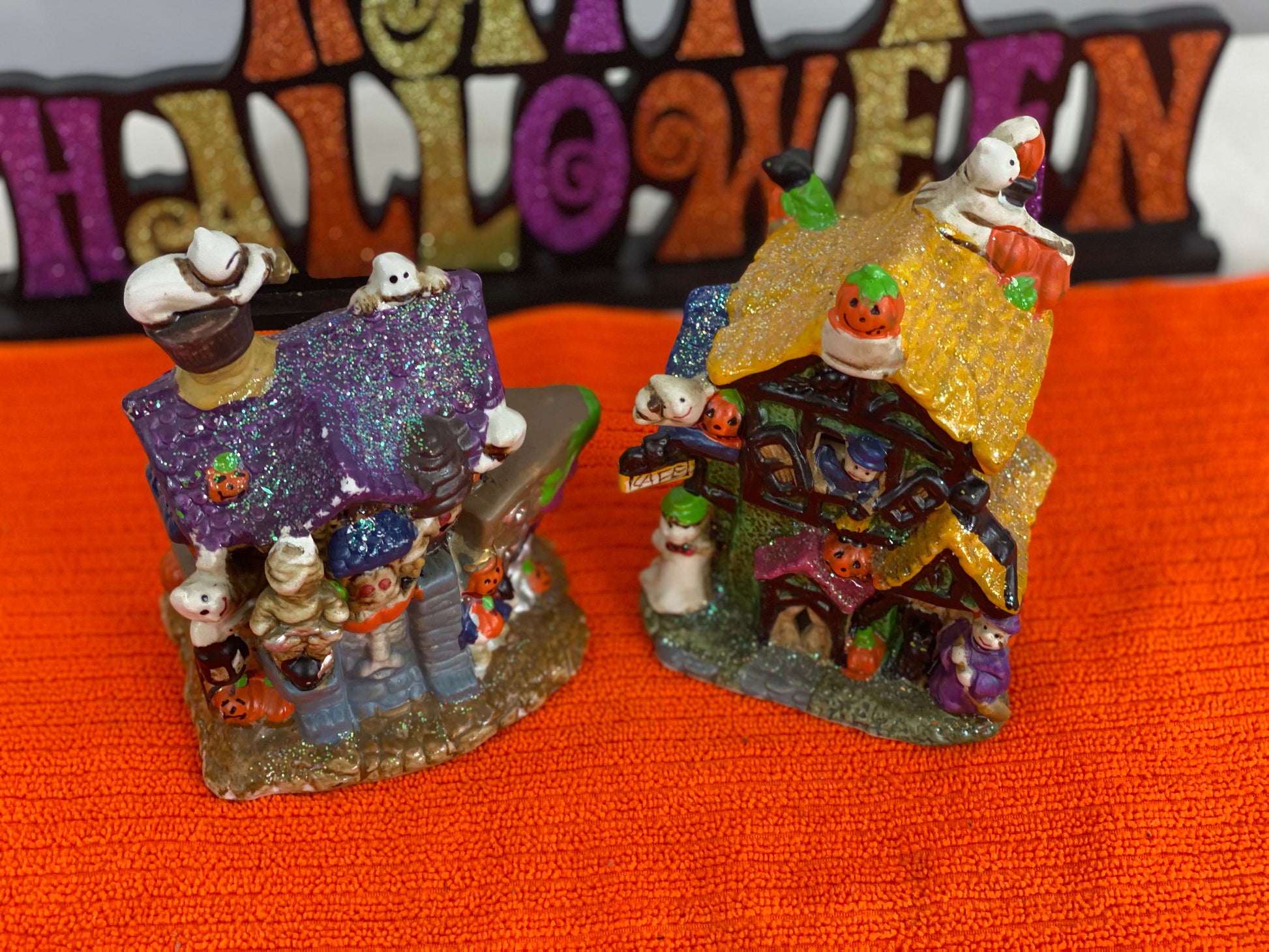 Set of Haunted Houses - Two (2)  Ceramic With Sparkly Finish  Many Decorations on Each House  Each House is Approx. 5”H x 4” W  Electric-Illumination