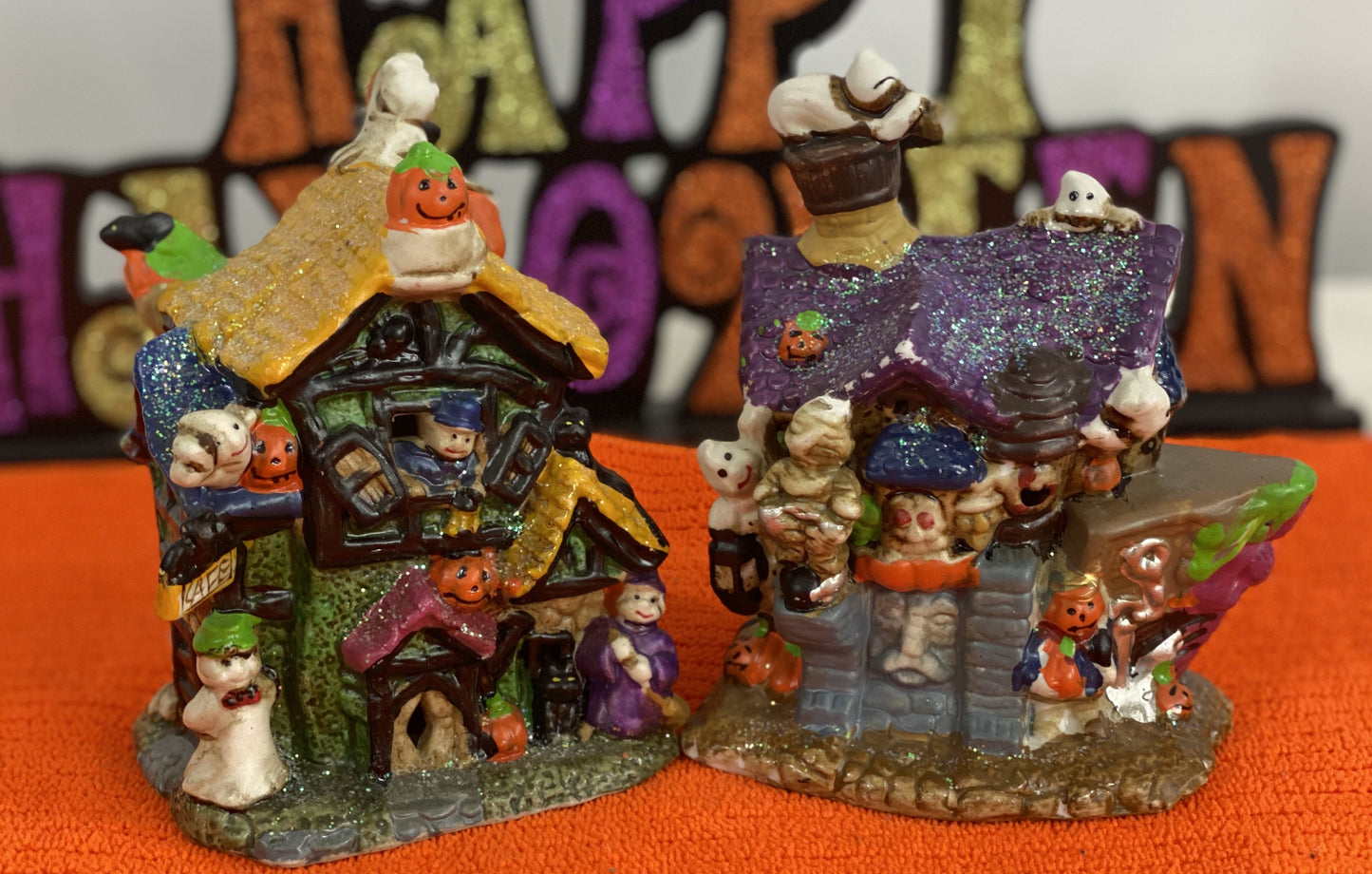 Set of Haunted Houses - Two (2)  Ceramic With Sparkly Finish  Many Decorations on Each House  Each House is Approx. 5”H x 4” W  Electric-Illumination