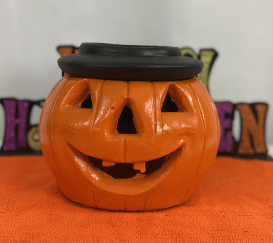 Orange Pumpkin with Black Hat  Made of Stone  Approx. 7.5” H x 6.5” W  Opening for Candle