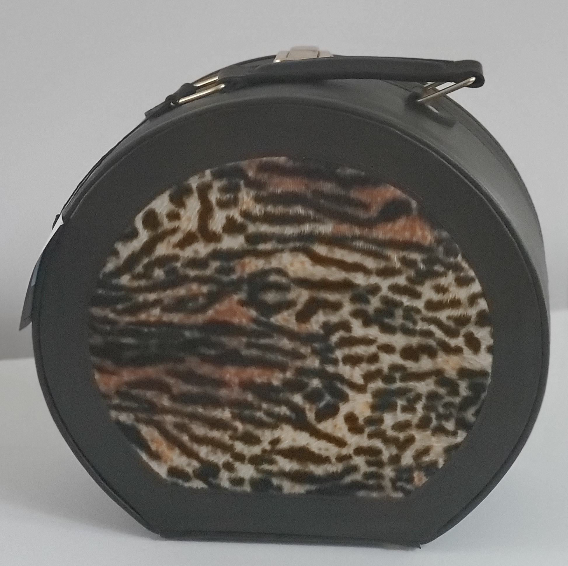 Leather Cosmetic Bag with Leopard Accent On Top and Bottom  Leather Handle for Carrying  Gold-Tone Clasp for Secure Closure  Approx Size:  11” W x 10” H x 5”  D  Round Shape