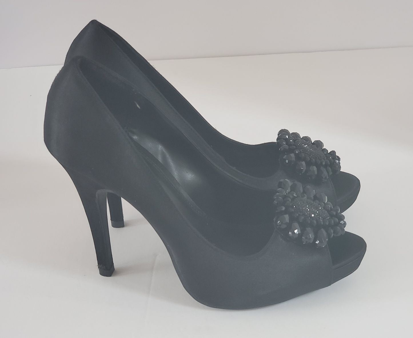 New - Excellent Condition   Black Satin Heels  Size 8.5  Approx 4.5” Heel  Open Toe  Accented with Beads at Toe of Shoe