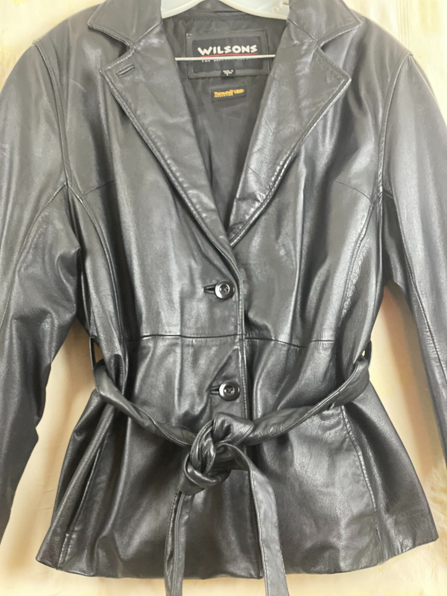 Pre-Owned - Excellent Condition   Soft-Leather Coat  Size Large  Two (2) Button & Belt Front Closure  Removable Lining  Two (2) Front/Side Pockets  25” Shoulder to Bottom; 23” Sleeve; 22” Across Chest