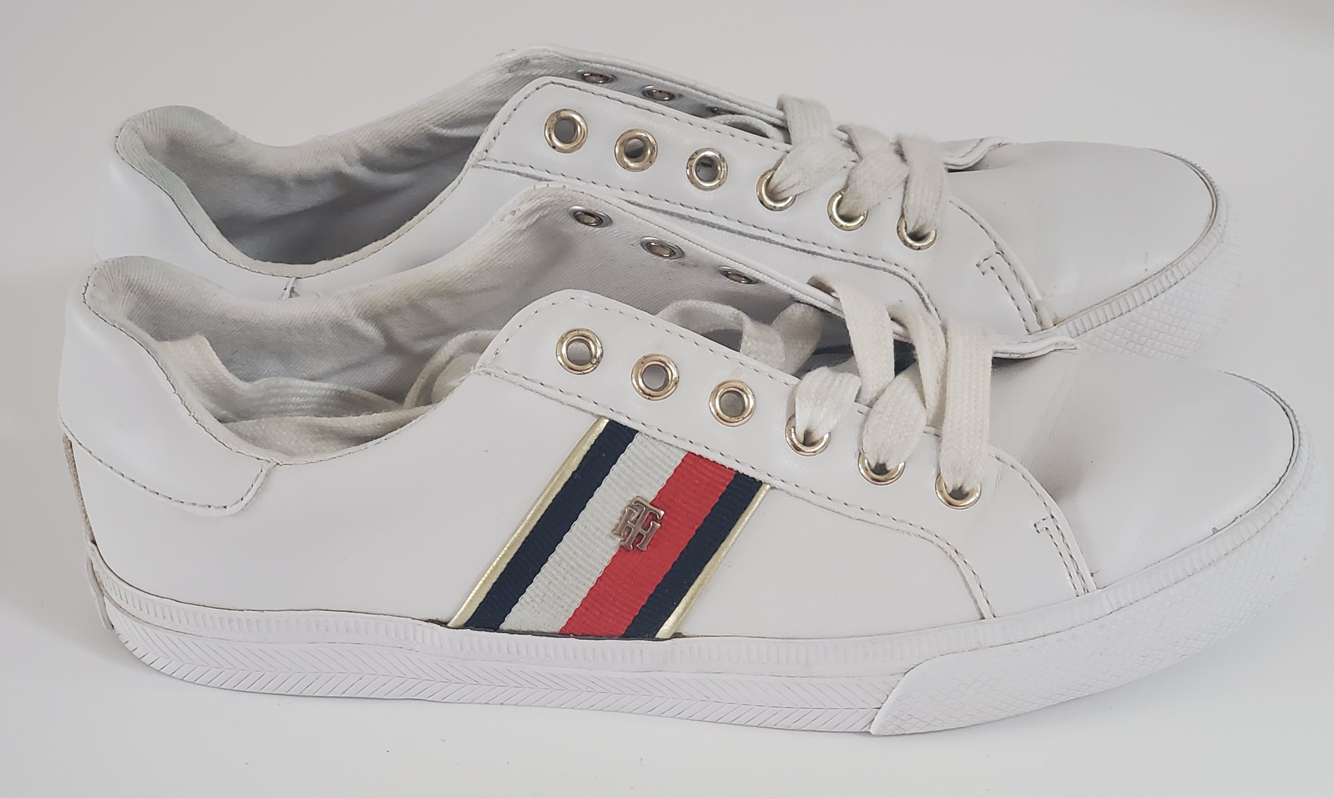 White with Red/White/Blue Stripe Accents  TH Initials on Side of Sneaker  Low Top - Lace up  Very Clean Pre-Owned Sneakers